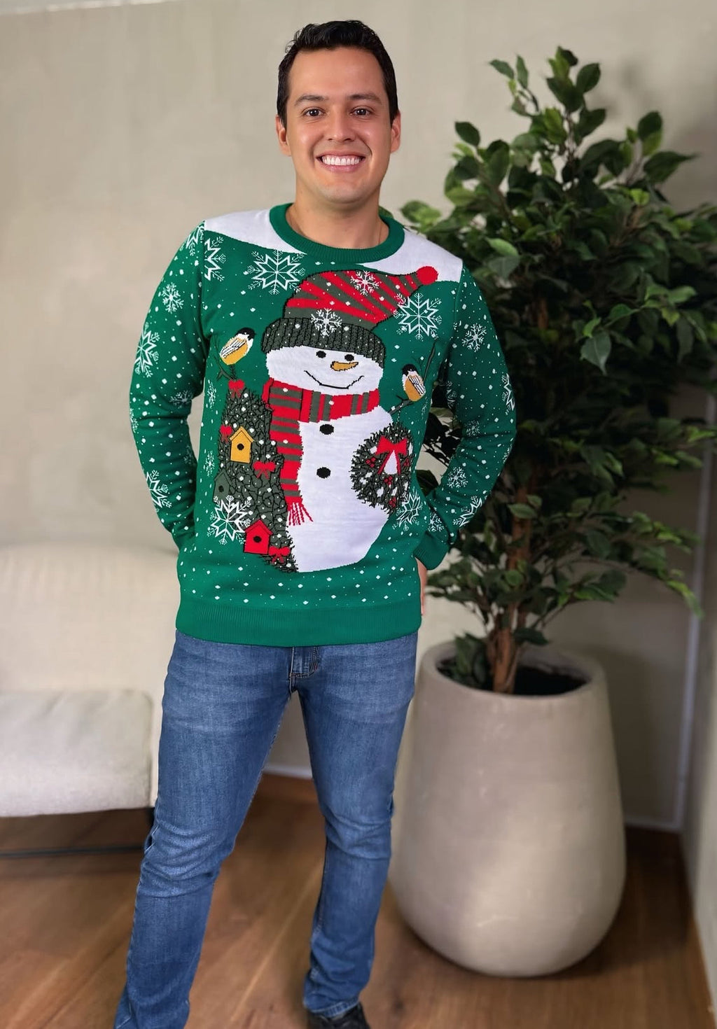 Man wearing a Soulan Store green and white knitted Christmas sweater with a festive snowman and snowflake design.